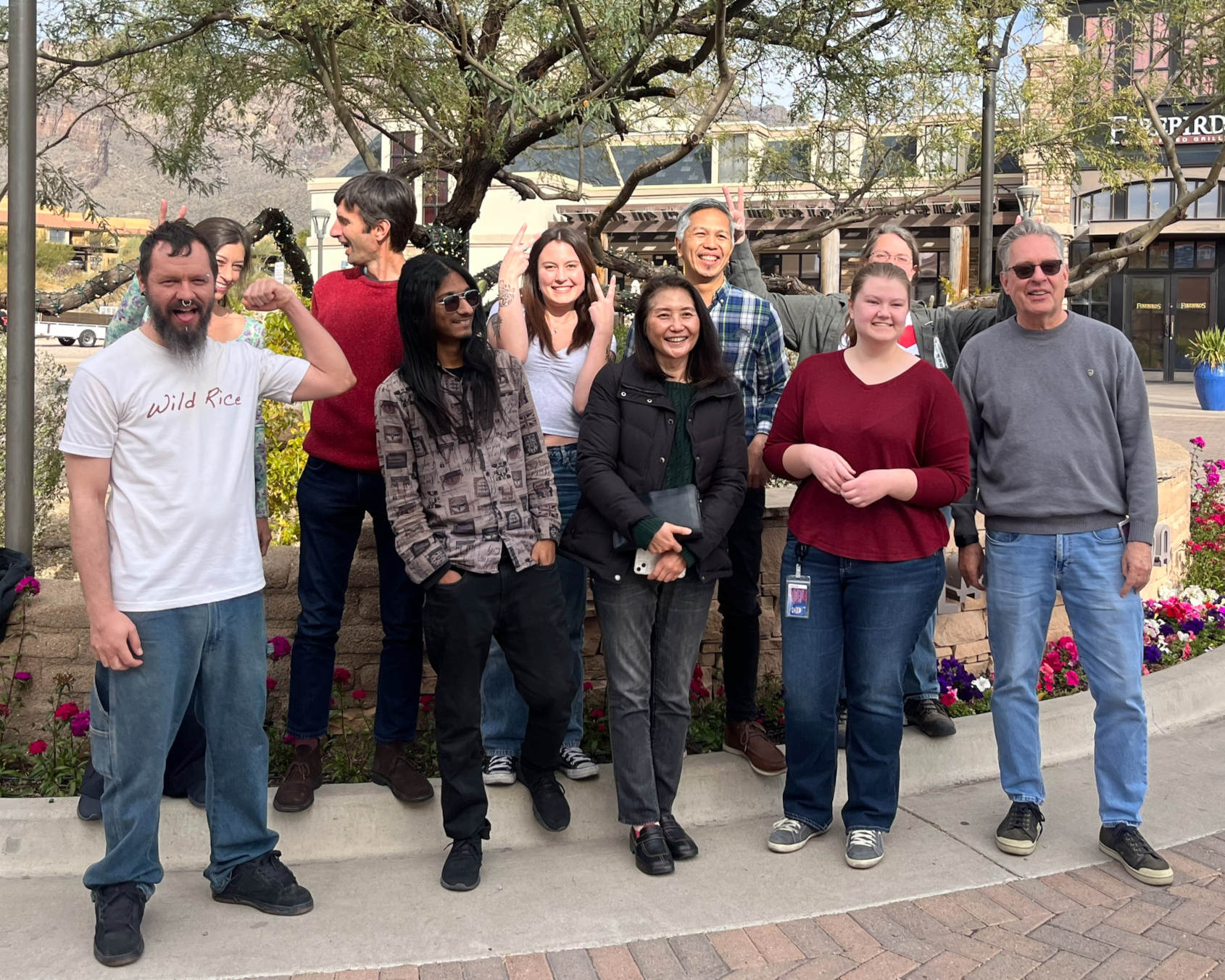 A picture of AGI group making silly faces at La Encantada, Jan 5 2024.  Chandler, Cassie, Dario, Michael, Kacy, Seunghee, Jayson, Rowan, Tiffany, Rod